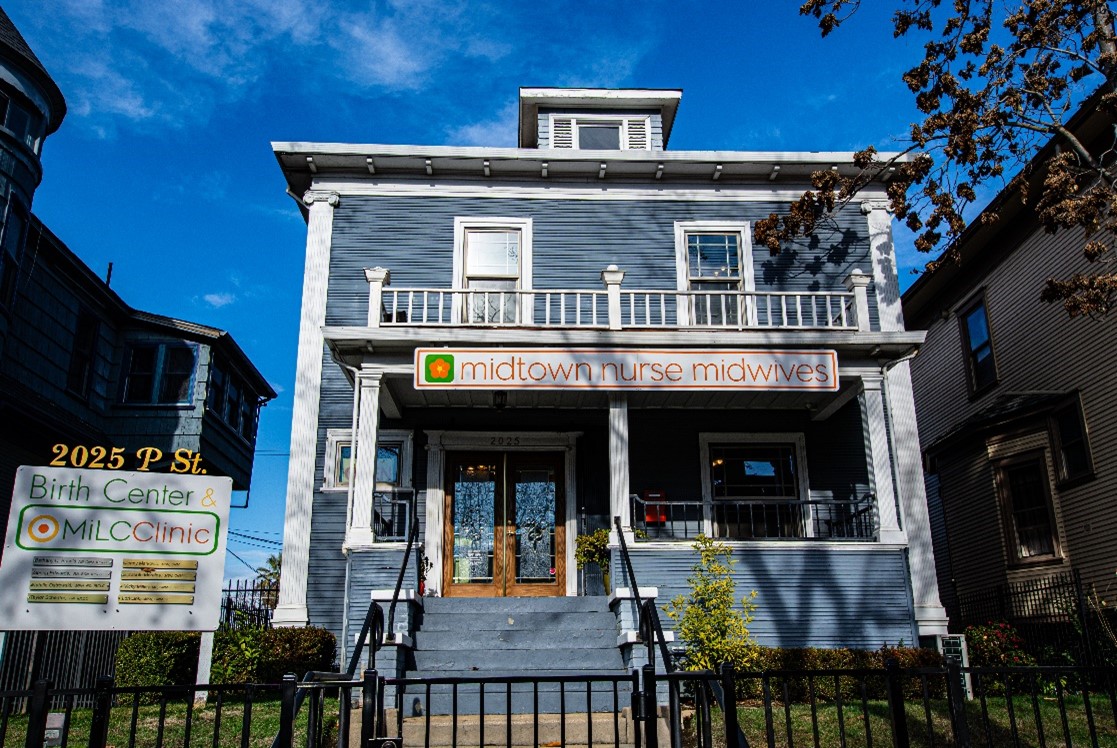 Colonial Revival style house. Blue with white trim. Two-story home.